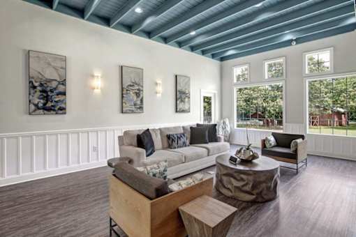 A living room with a white couch and a wooden coffee table.