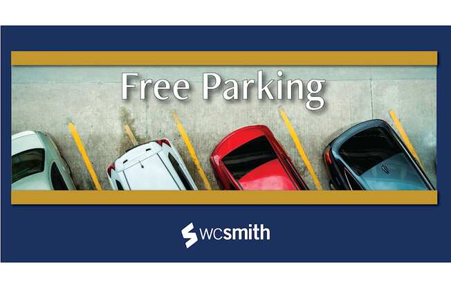 free parking sign with several cars parked in a parking lot