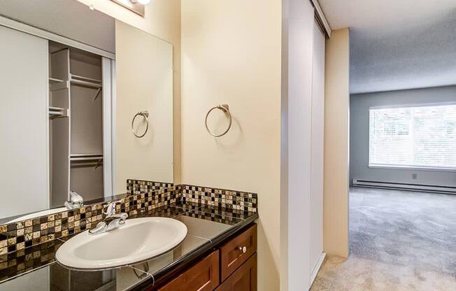 a bathroom with a sink and a mirror at The Bluffs at Mountain Park, Lake Oswego