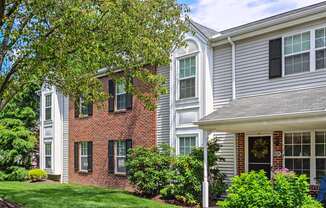 Beautiful exterior of Westridge gardens with green grass, tall trees, and bushes