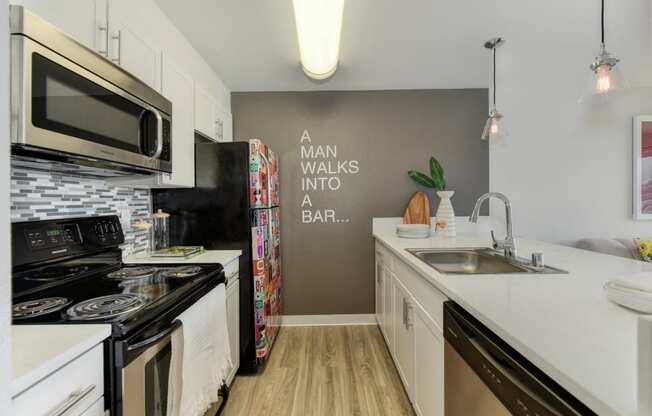 Kitchen with Hardwood Inspired Floor, Oven, Stove and Cabinets