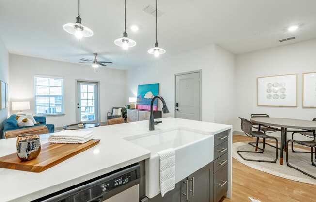 luxe amenity package with farmhouse sink, gooseneck faucet, and pendant lighting cottage open floor plan with luxe amenity package at Anthem Apartments and Cottages in Huntsville, Alabama