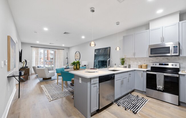 a kitchen with an island and a living room with a dining room