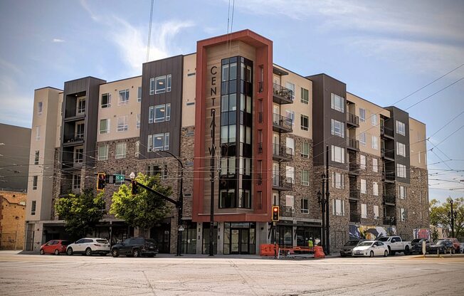 A large apartment building with a traffic light in front of it