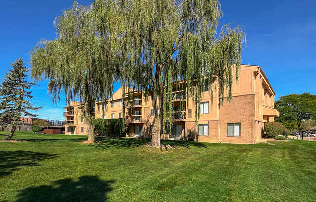 A large building with a tree in front of it.