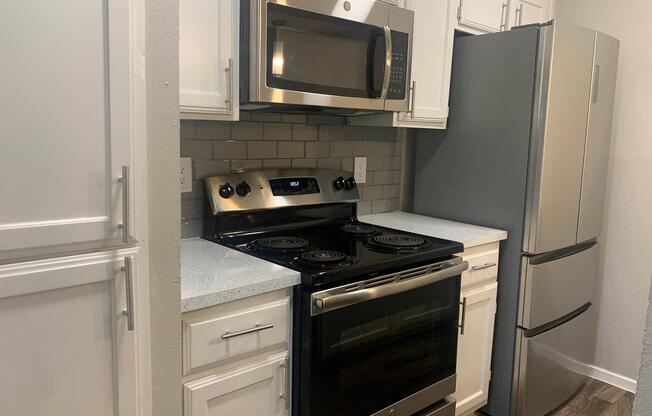 a stove top oven sitting inside of a kitchen