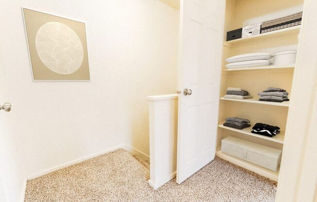 a closet with shelves and a white door