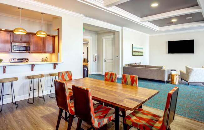 A dining room with a wooden table and chairs.