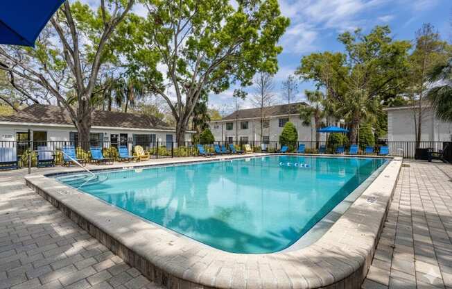 A rectangular pool with a curved edge and a brick border.