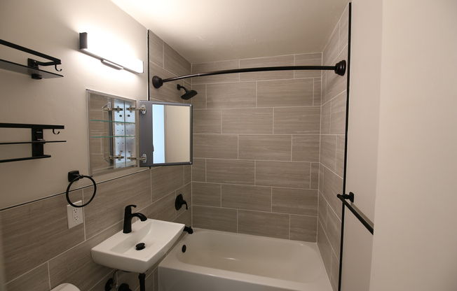 Modern bathroom with sleek fixtures, elegant lighting, and chic tile design creating a soothing atmosphere.