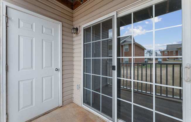 A white door is on the left and a glass door is on the right.