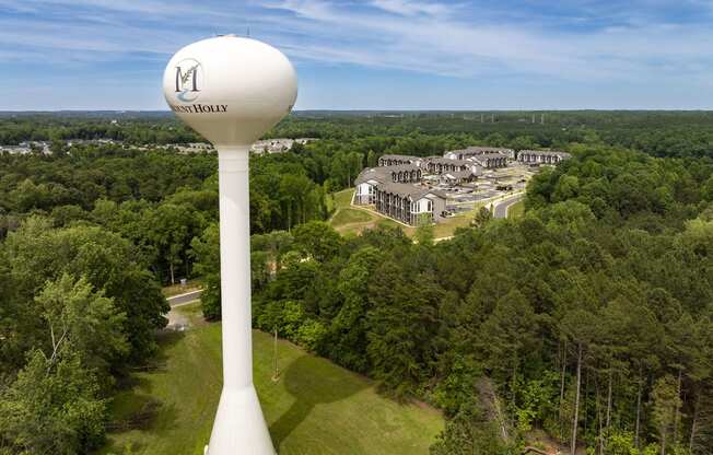 an aerial view of a water tower with buildings in the background