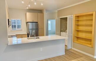 A kitchen with a white countertop and wooden flooring at Wilsonville Summit Apartments, Oregon, 97070