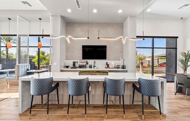 A modern kitchen with a bar area and a television above it.