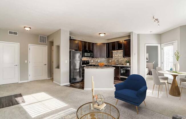 A modern kitchen with a blue chair in the foreground.