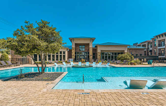 a large swimming pool with a building in the background at Discovery at Craig Ranch, McKinney, TX