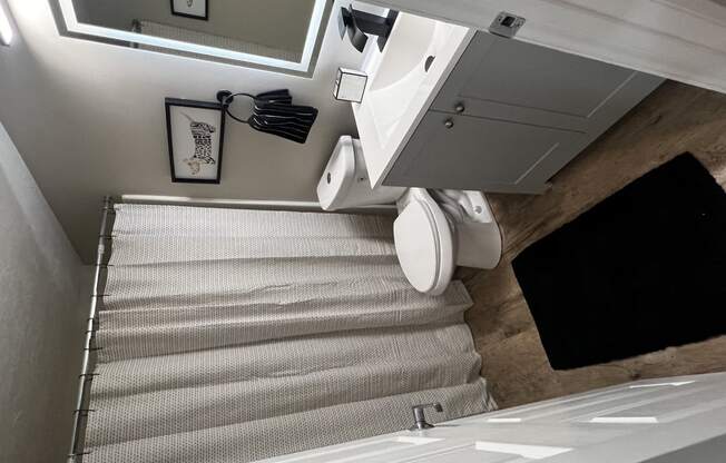 a small bathroom with a staircase with a toilet and a sink