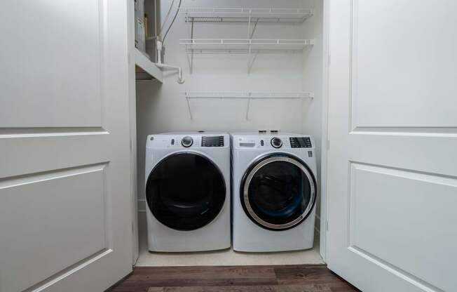 Two front loading washing machines in a laundry room.