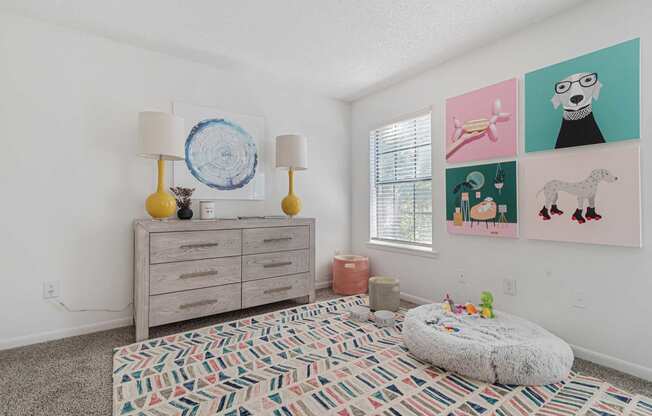 a bedroom with a dresser and a window