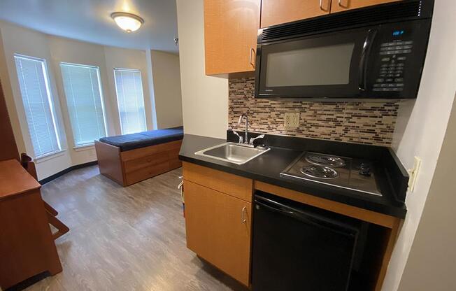 a small kitchen with a stove and a microwave