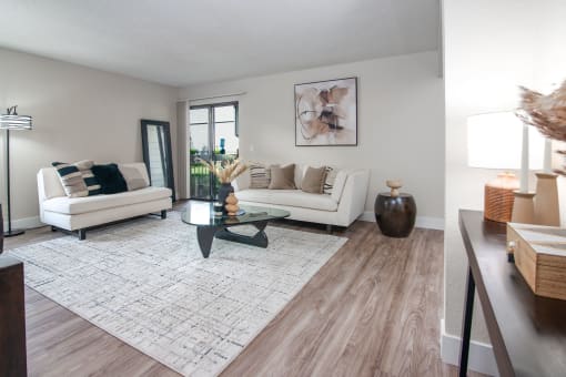 Model apartment living room with two couches and a coffee table