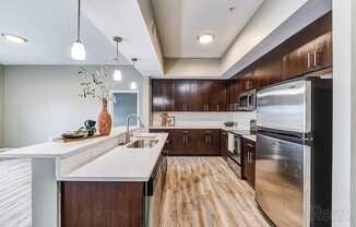 A modern kitchen with wooden cabinets and stainless steel appliances.