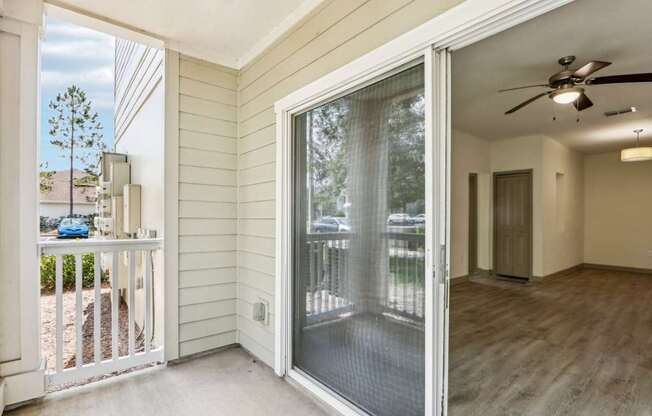 Fenced in Royal Palm patio with sliding glass doors leading inside at Oakleaf Plantation Apartments in Jacksonville, FL