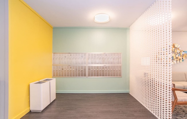 a living room with yellow and white walls and a white room divider