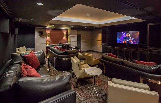 a living room with couches and chairs and a television