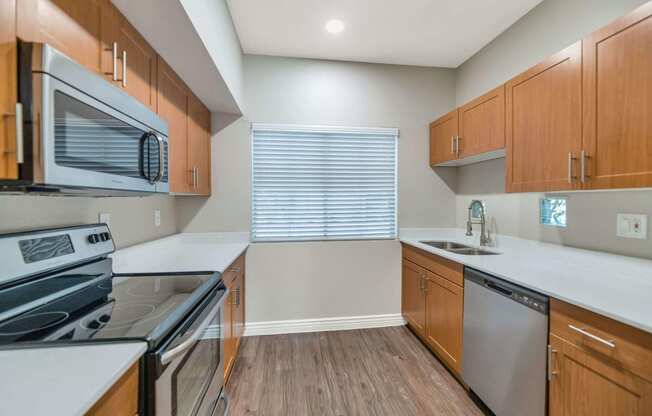 a modern kitchen with wood cabinets and stainless steel appliances