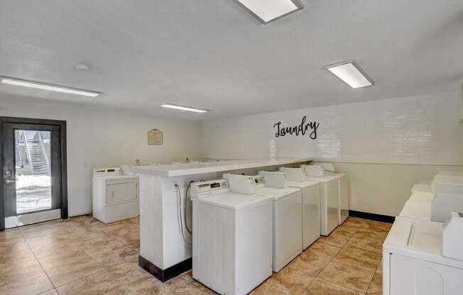 Laundry room with washers and dryers.