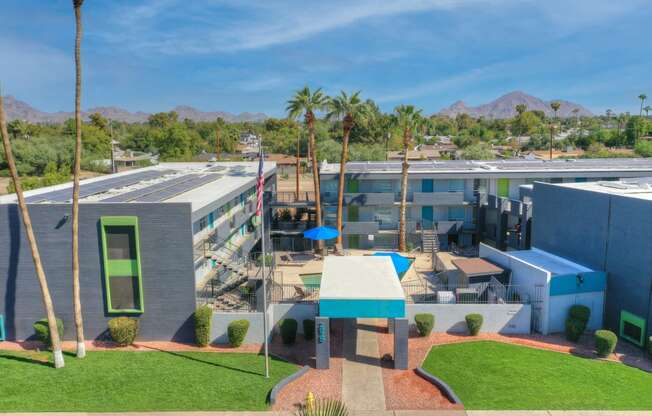 an aerial view of a building with palm trees