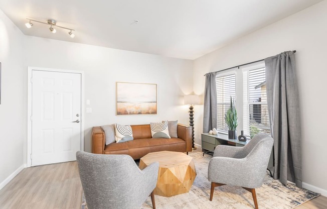 a living room with a couch and two chairs