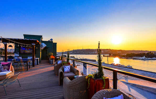 rooftop lounge at sunset with lounge chairs