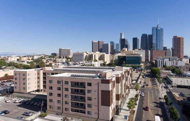 A cityscape with tall buildings and a clear blue sky.