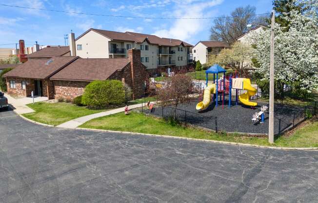 a playground in front of a house with a childs