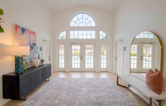 A large room with a long bench and a large rug.