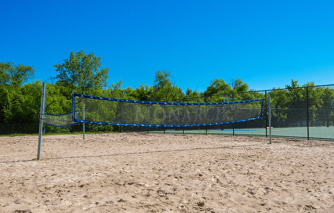 a tennis court with a net in the sand