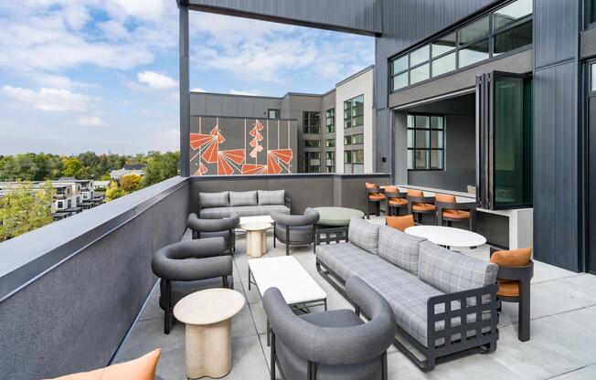 An inviting terrace at Modera University Park, designed for relaxed gatherings with neighborhood views and easy access to University Park below.