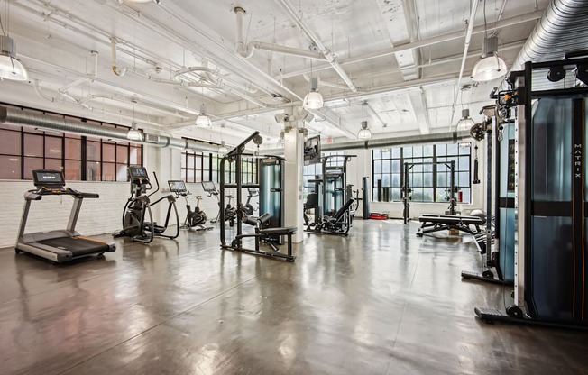 A gym with treadmills, exercise bikes and other equipment.