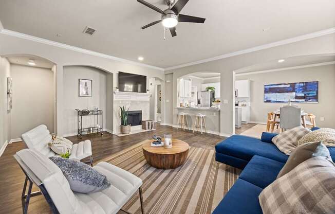 A living room with a white chair and a blue couch.