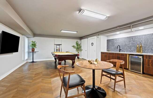 A room with a pool table and a television.
