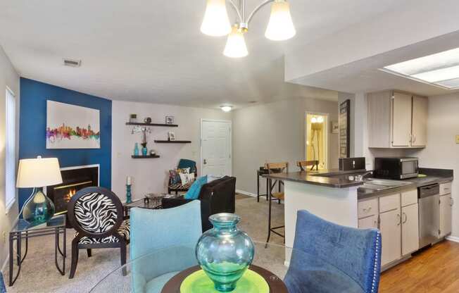 a living room and kitchen with a dining room table and chairs