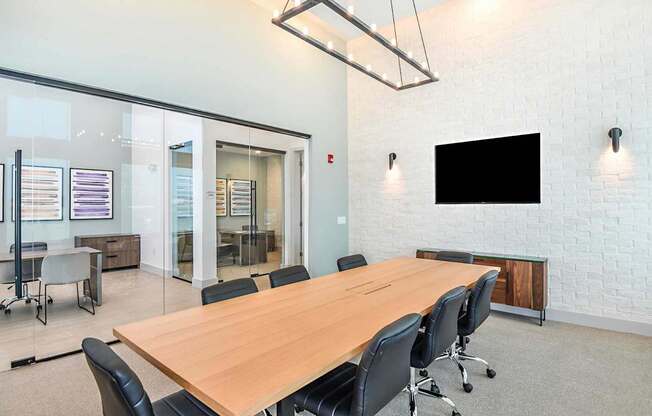 A conference room with a long table and chairs.