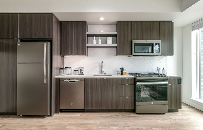 a kitchen with stainless steel appliances and wooden cabinets