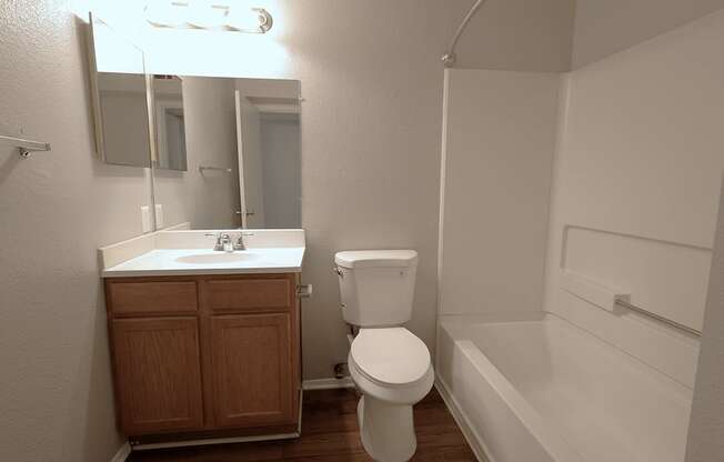 an empty bathroom with a toilet sink and bath tub