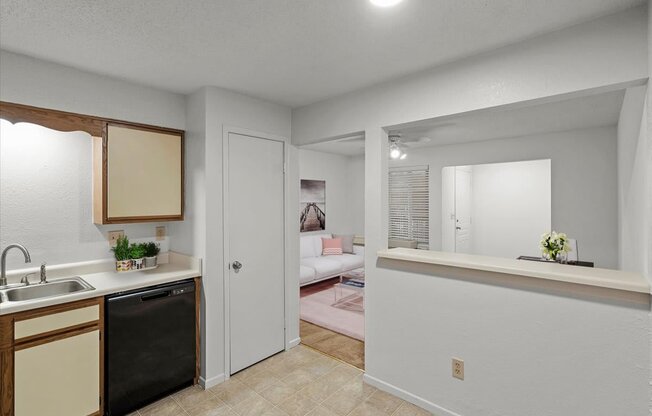 a kitchen with a view of a living roomat Millcreek Woods Apartments, Olathe, Kansas
