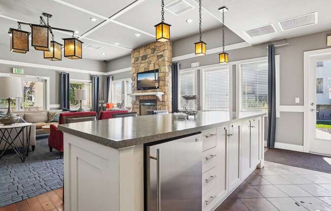 A kitchen with a large island and a stone backsplash.