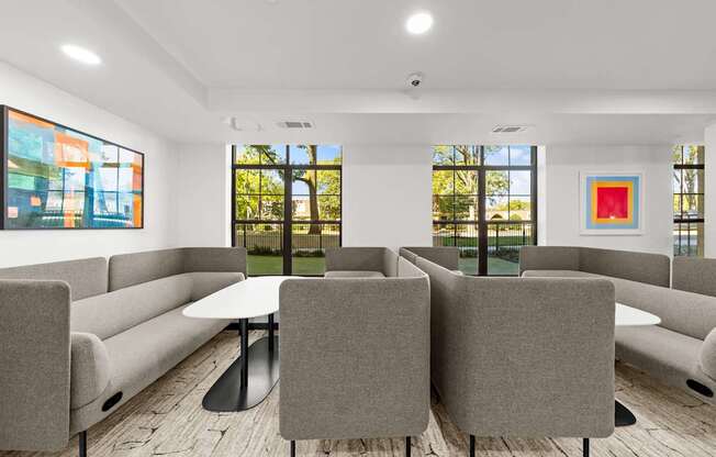 A conference room with a table surrounded by grey chairs.
