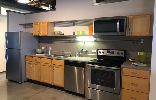 a kitchen with stainless steel appliances and wooden cabinets